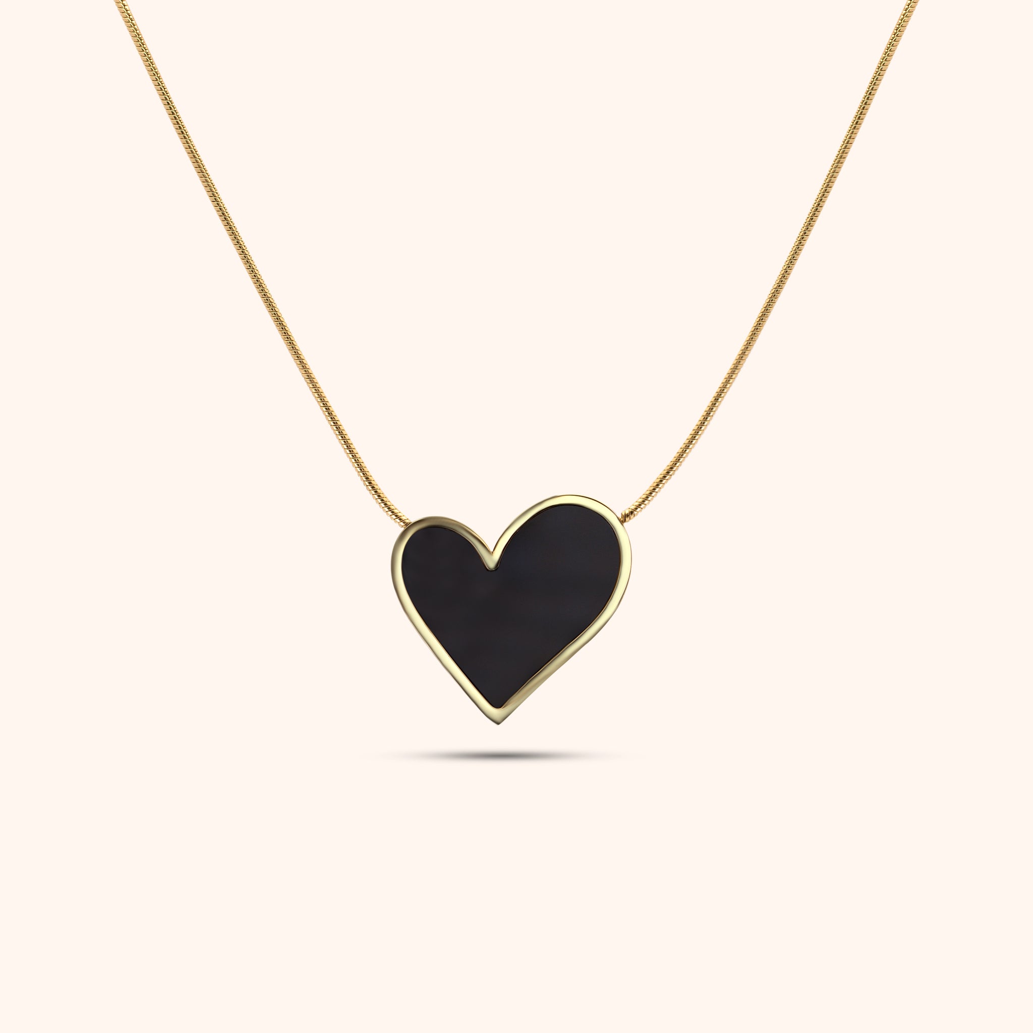 Gold necklace with a black heart-shaped pendant, titled Noir Soul Pendant Necklace